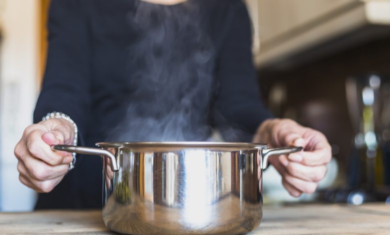 mujer olla agua hirviendo